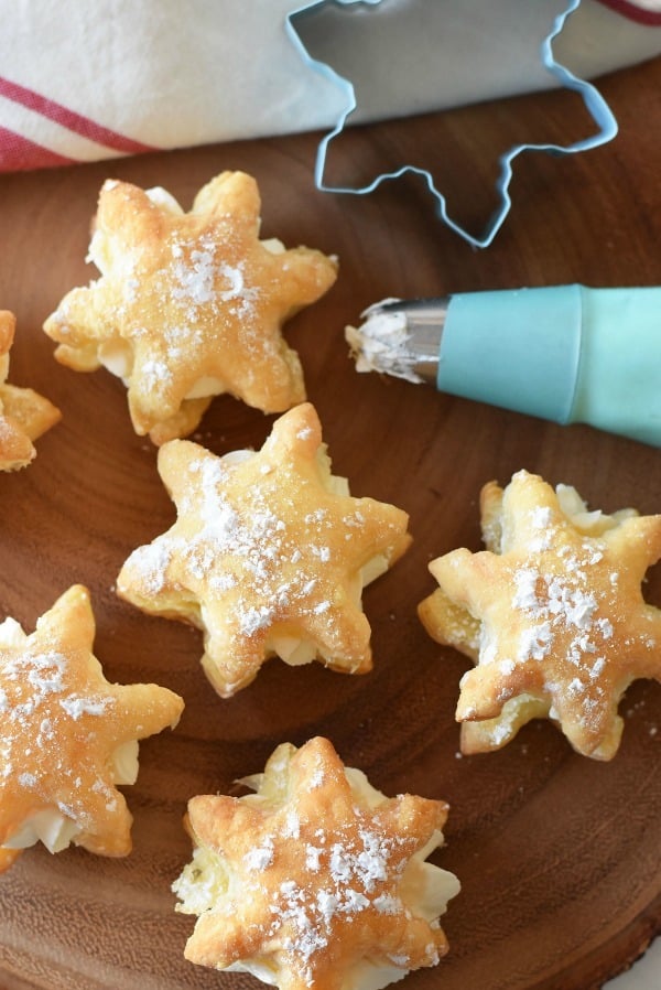 Snowflake cookie cutter near snowflake cream puffs. 