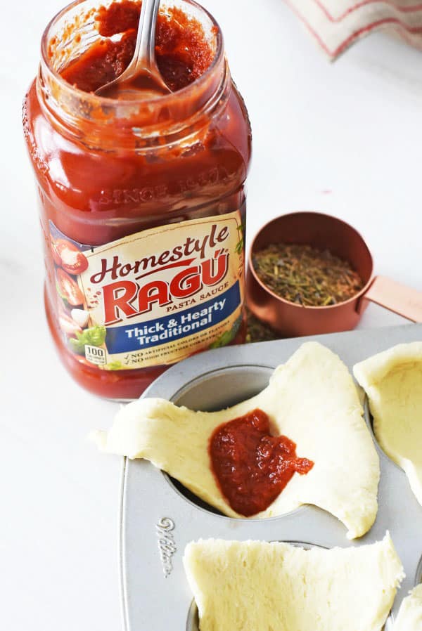Ragu homestyle sauce in raw crescent dough pieces. 