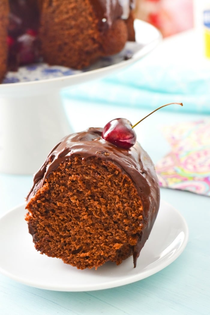 A chocolate slice of mayonnaise cake with a cherry on top. 