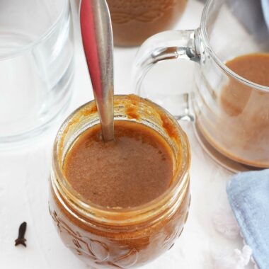 Homemade Pumpkin Spice Syrup in glass jar with spoon