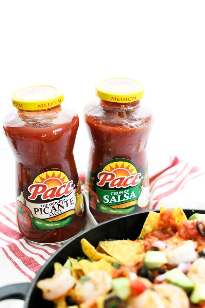 2 bottles of Pace Salsa behind a skillet of nachos