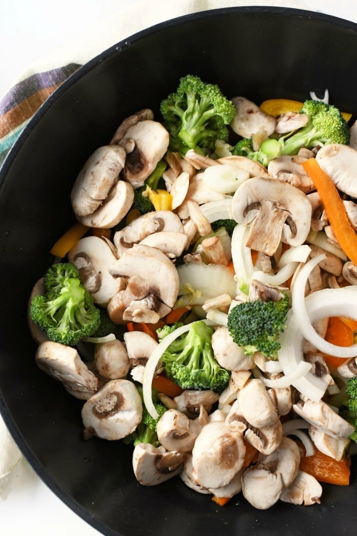 Veggie stir fry vegetables inside a cast iron pan.