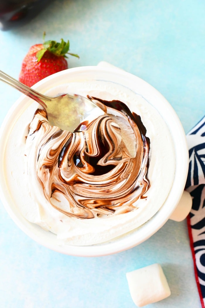 Chocolate Cool Whip dip with spoon in bowl.