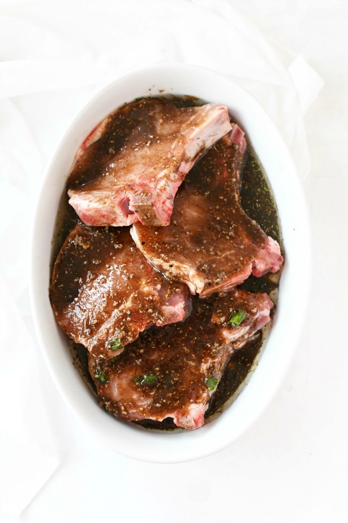 Marinaded Asian Chops in white dish.