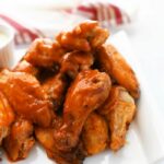 Oven-Baked Buffalo Wings on a white platter.