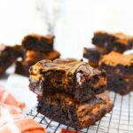 Pumpkin Fudge Brownies on a cooling rack with a bite missing