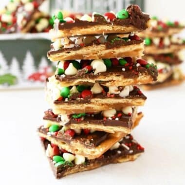 Christmas Toffee Candy stacked on top of each other on a white table.