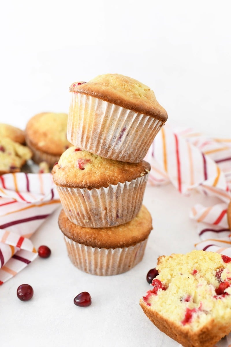 Orange Cranberry Muffins stacked on top of each other.