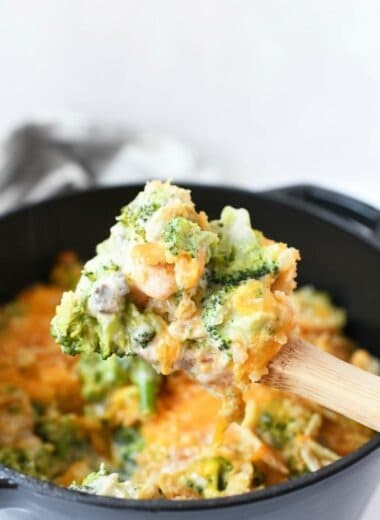 Broccoli Cheese Casserole no rice on a wooden spoon steaming hot.