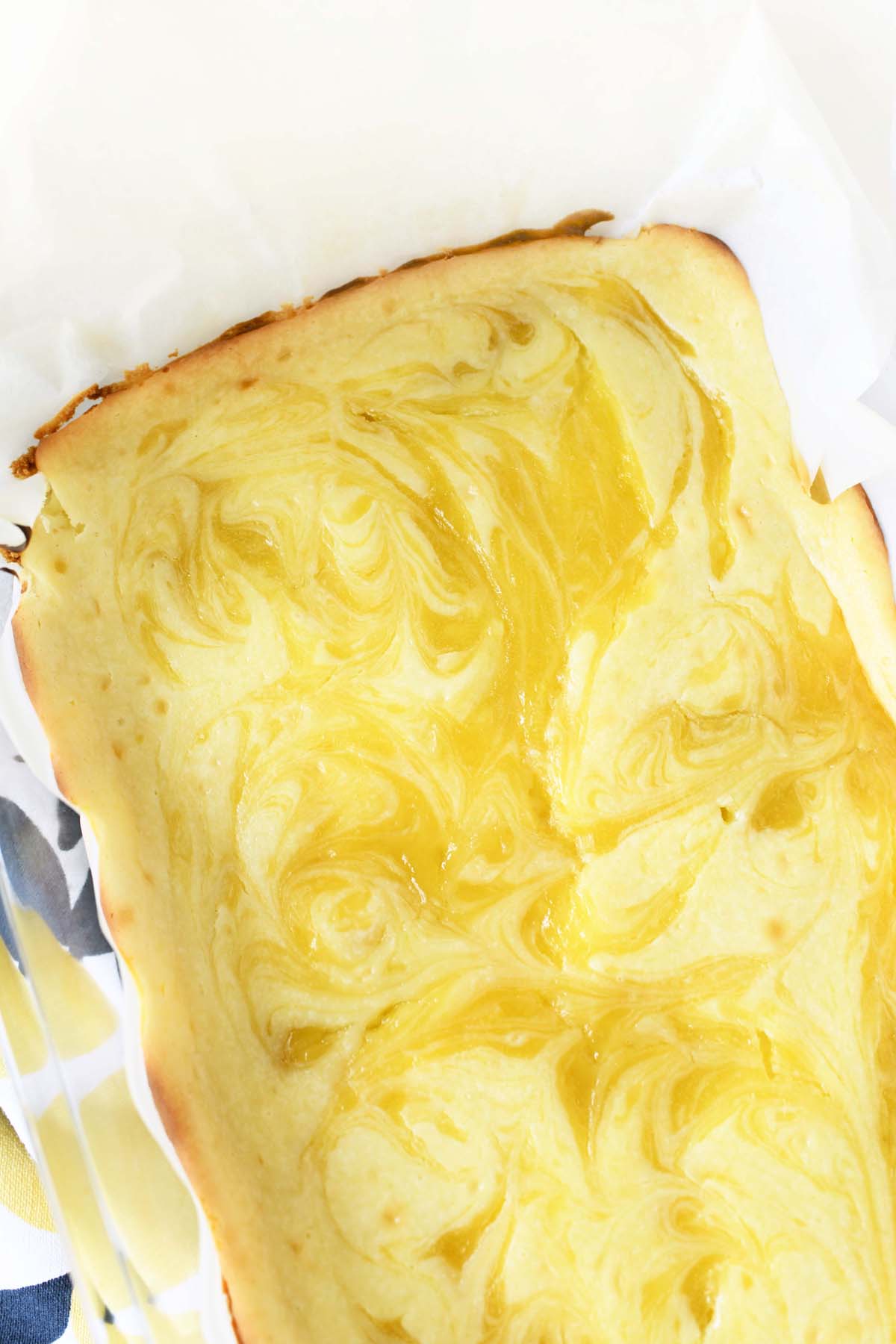 Lemon Swirled cheesecake bars baked and in a pan.