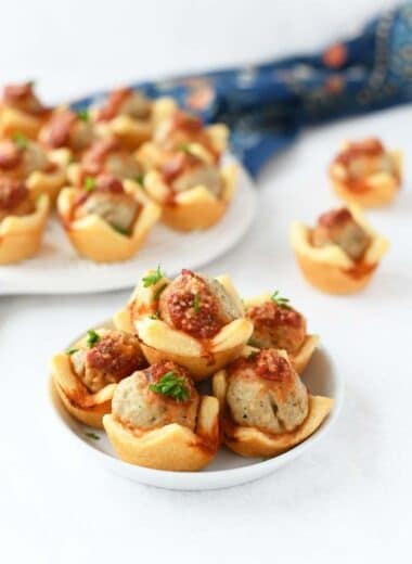 Meatball Crescent Bites on a small white platter with a blue, floral napkin.