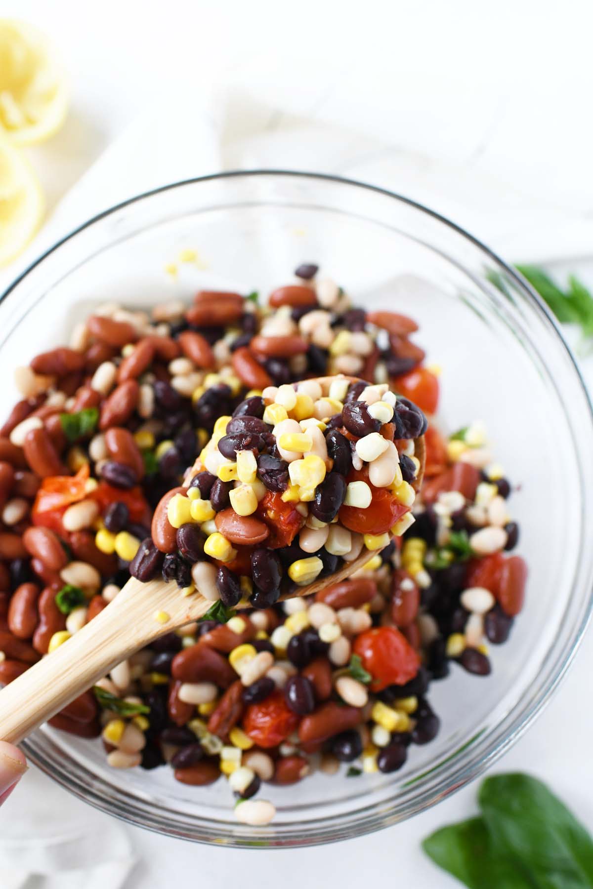 3 bean salad on a wooden spoon.
