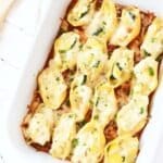 Summer Squash Stuffed Shells baked in a white pan.
