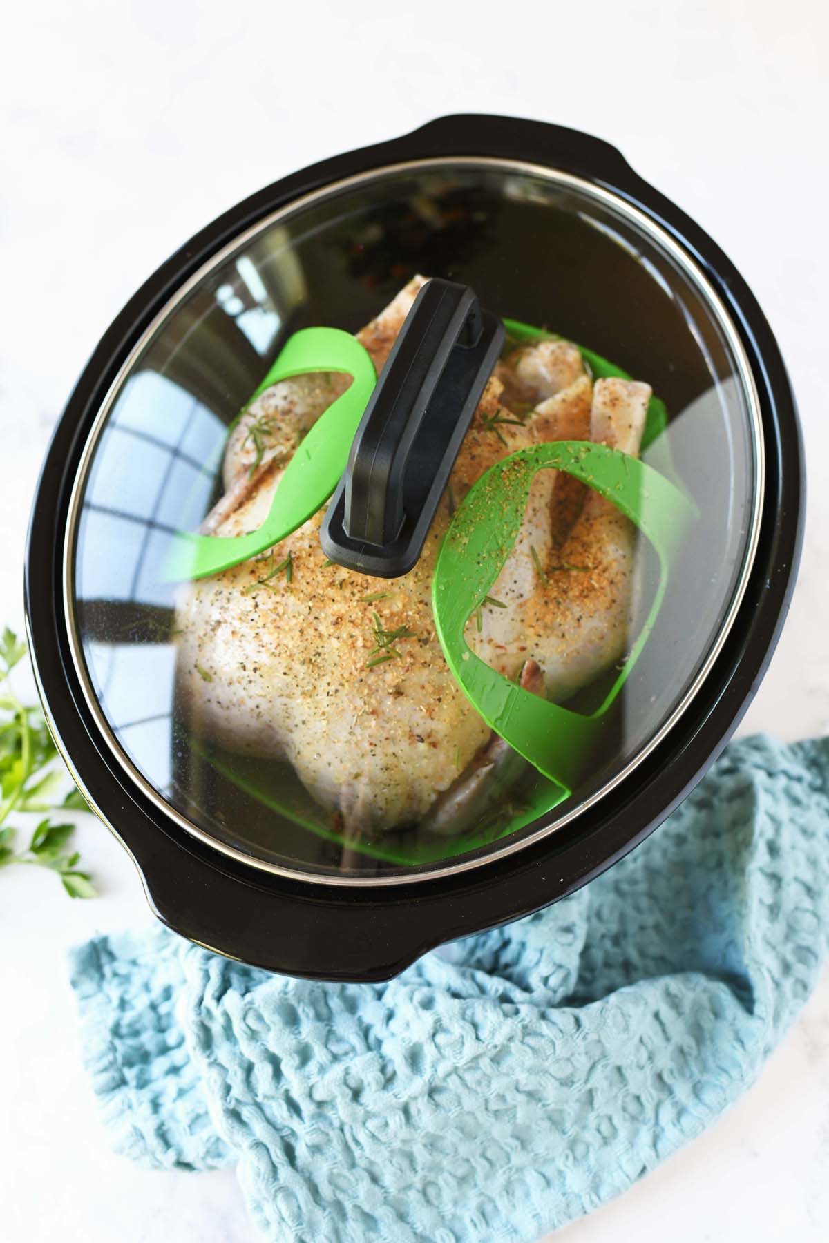 Chicken in a black Slow Cooker.
