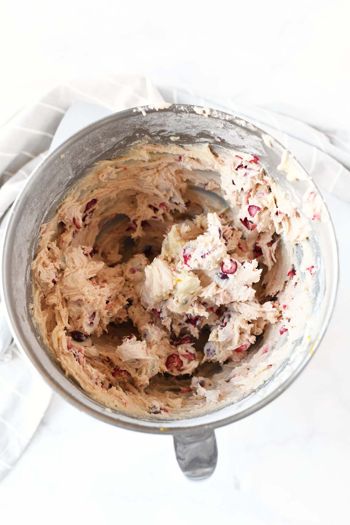 Cranberry Christmas cake batter in a stand mixer.