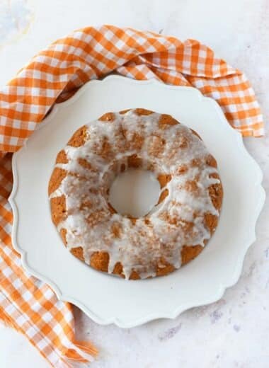 Two Ingredient pumpkin spice cake on a white scalloped plate.