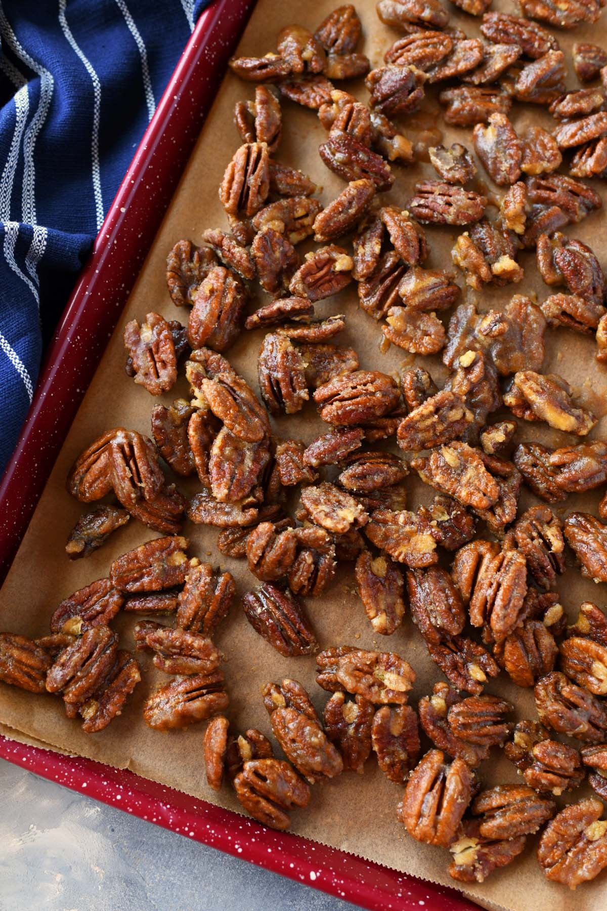 Candied Pecans on a baking sheet with parchment paper.