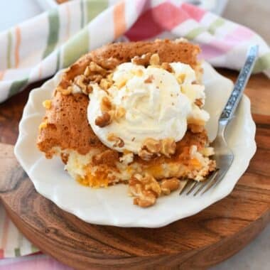 Peach angel food cake with whipped cream and walnuts.