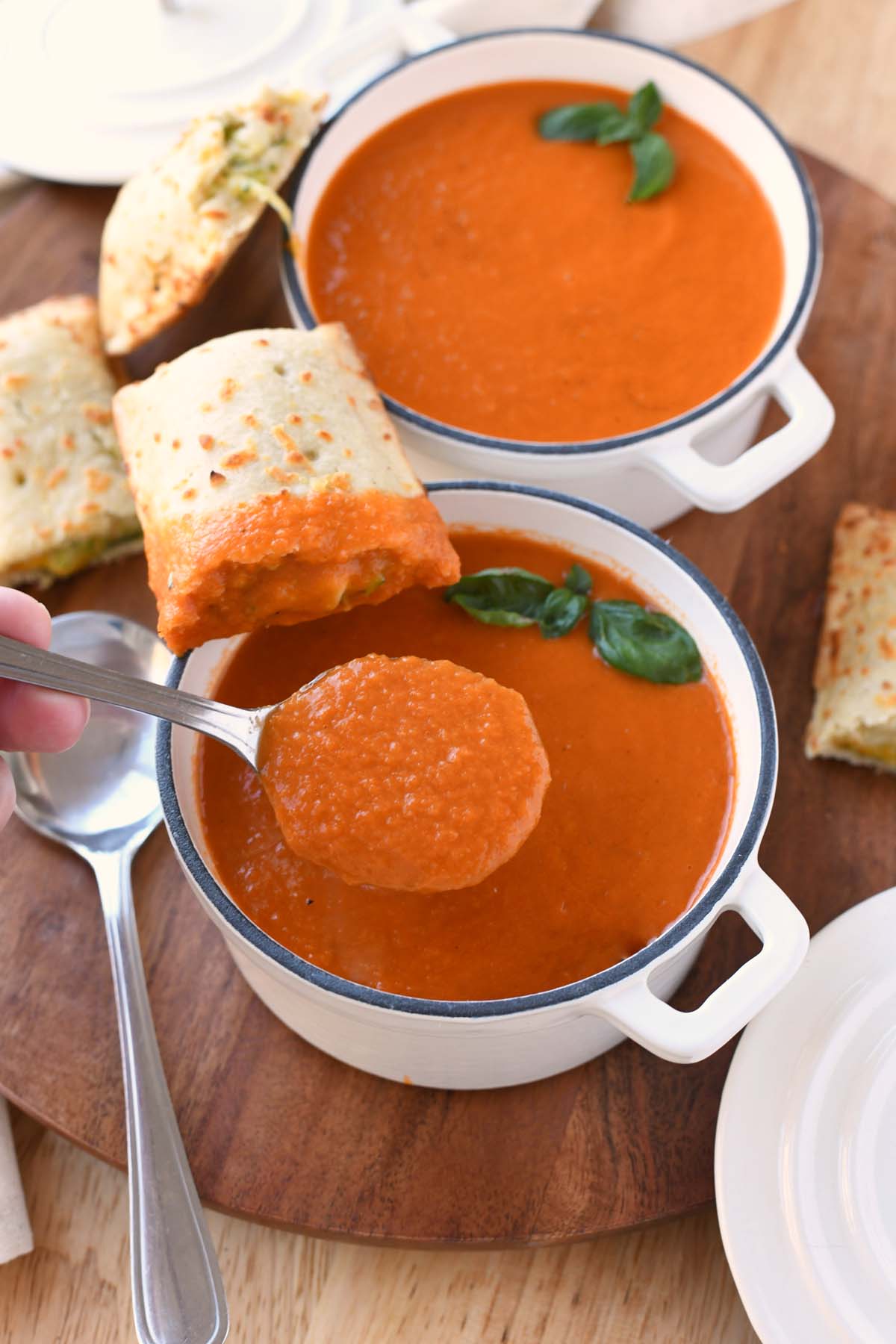 Tomato soup on a silver spoon.