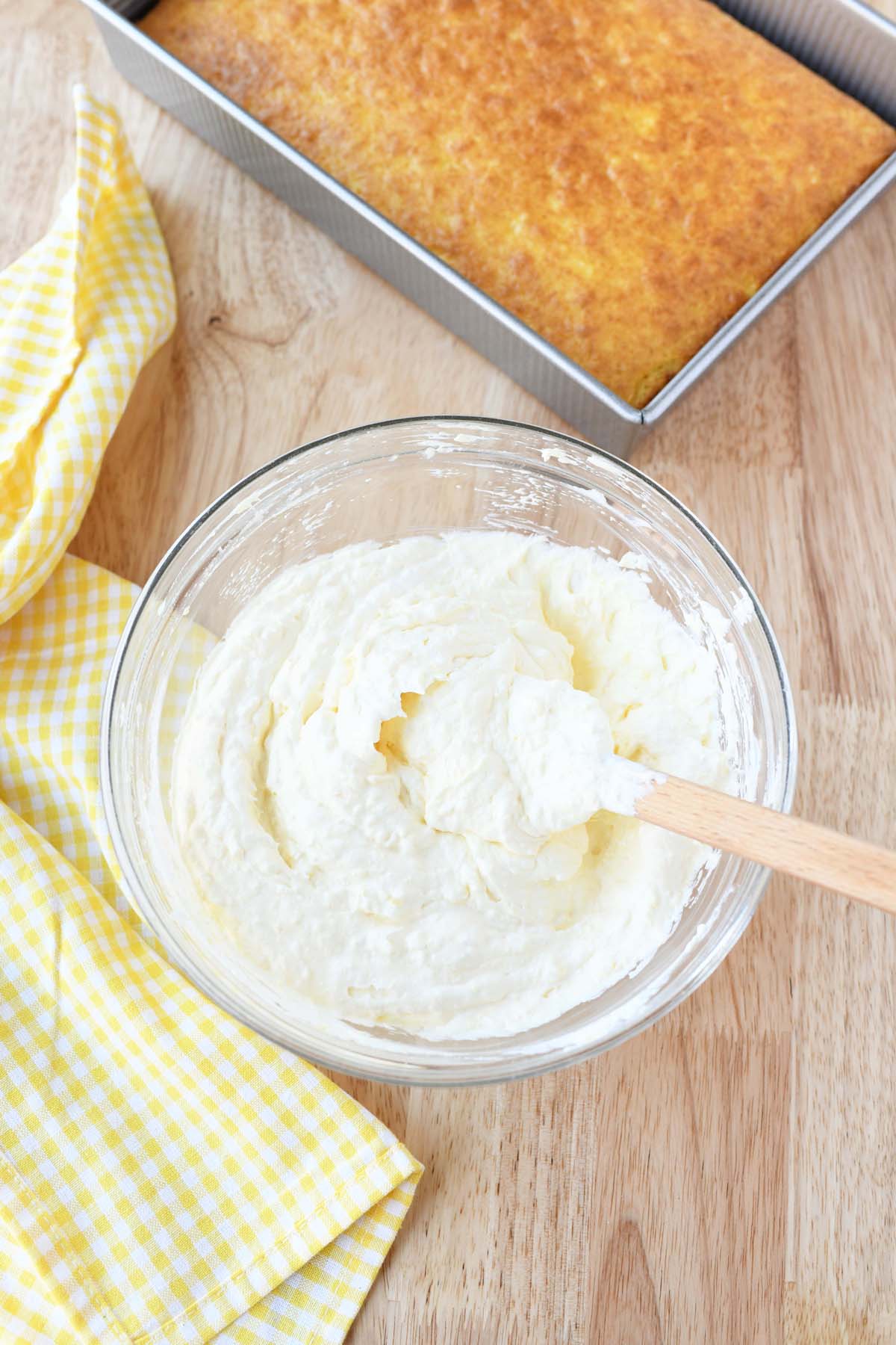 Fluffy pineapple frosting in a glass bowl.