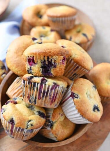 Fluffy blueberry cake mix muffins in a wooden bowl.