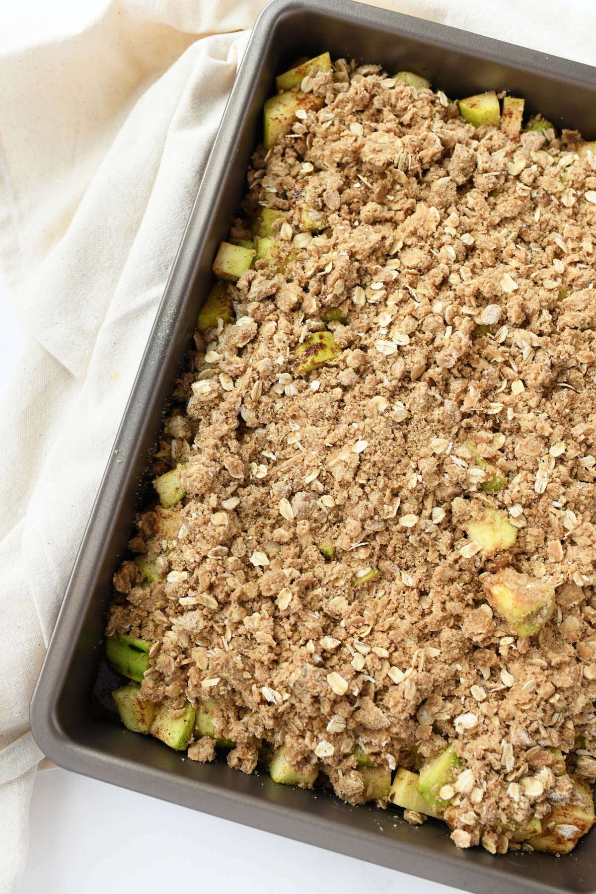 A pan of unbaked zucchini crisp.
