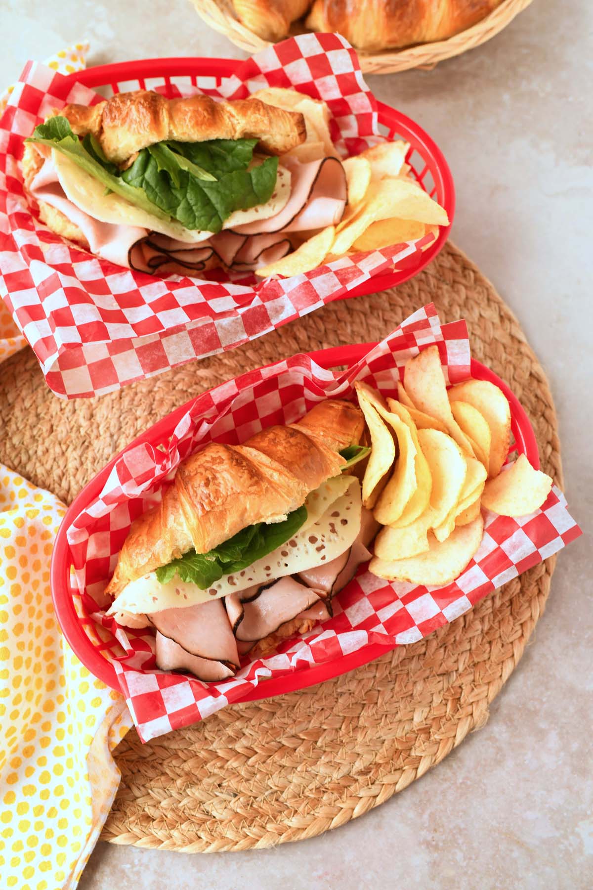 Ham and Cheese Croissants in red baskets with red, checkered liners.