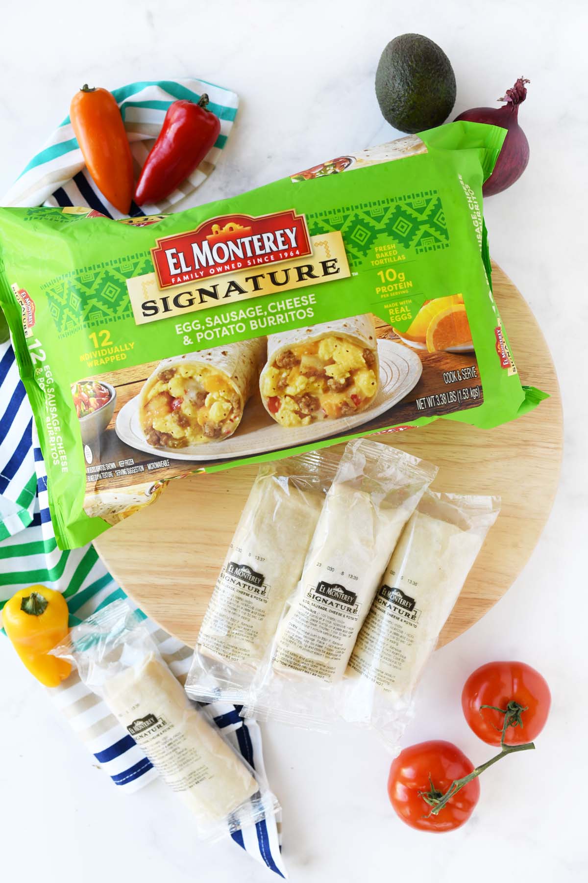 Monterey Burritos in a  green package and near fresh produce.