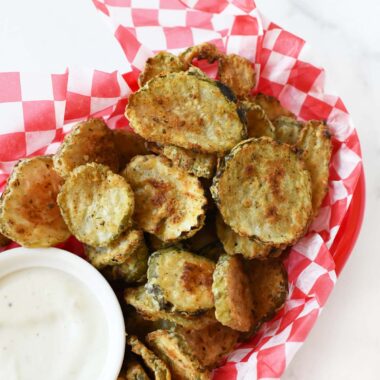 Air Fried Pickles in a red and white basket.