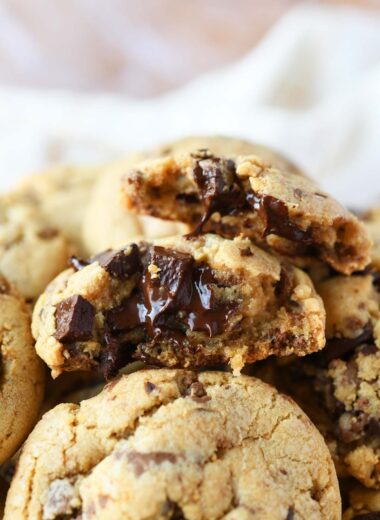 A stack of chocolate chunk cookies exposing the chocolaty goodness inside.