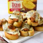 Toasted chicken parmesan toasts with a hand grabbing a NY bakery box in the background.