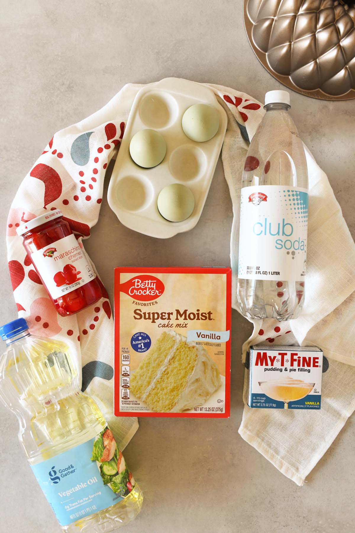 Maraschino cherry cake recipe ingredients on a stone table.