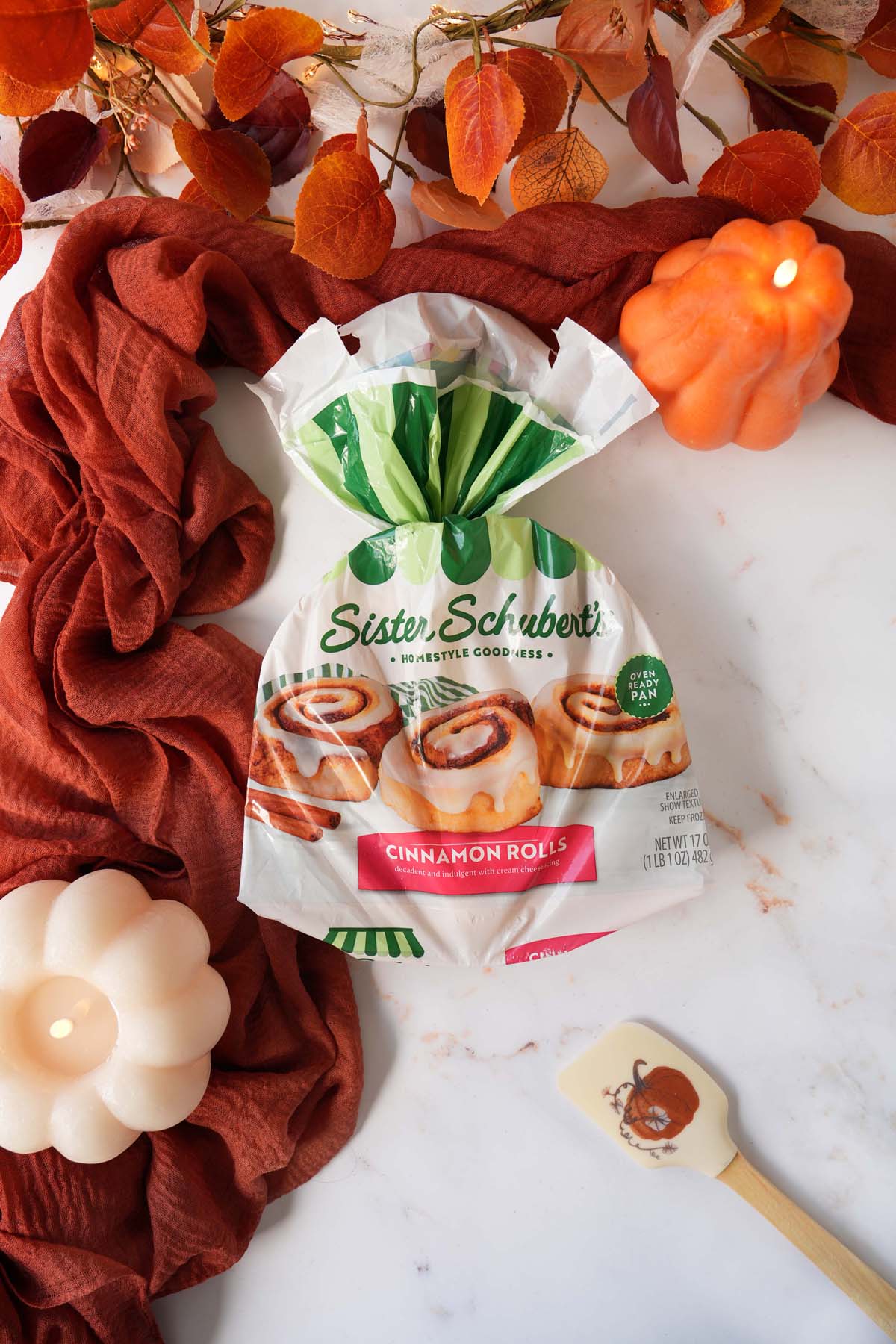 Sister Schubert's roll package on marble table with fall themed napkin and props.