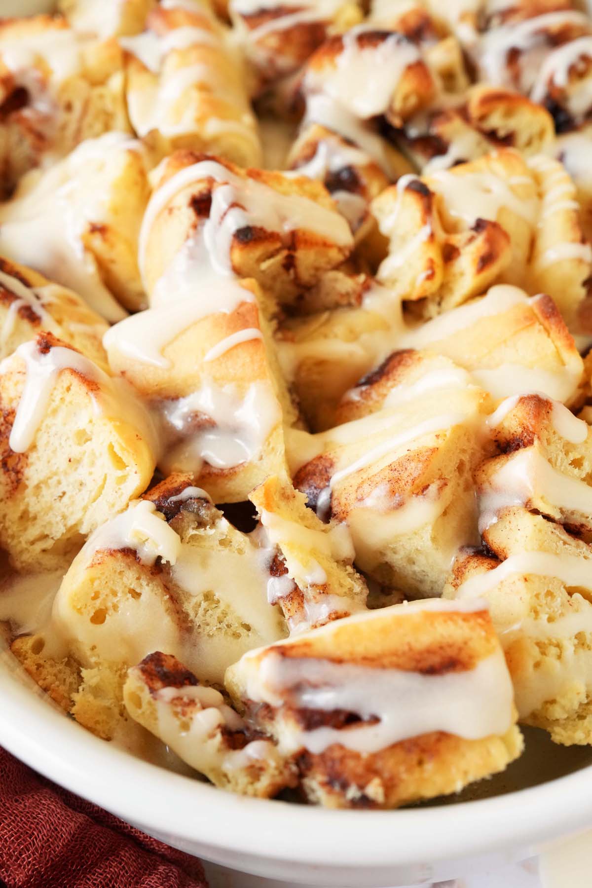 An up-close shot of apple cinnamon bun casserole in a white dish.