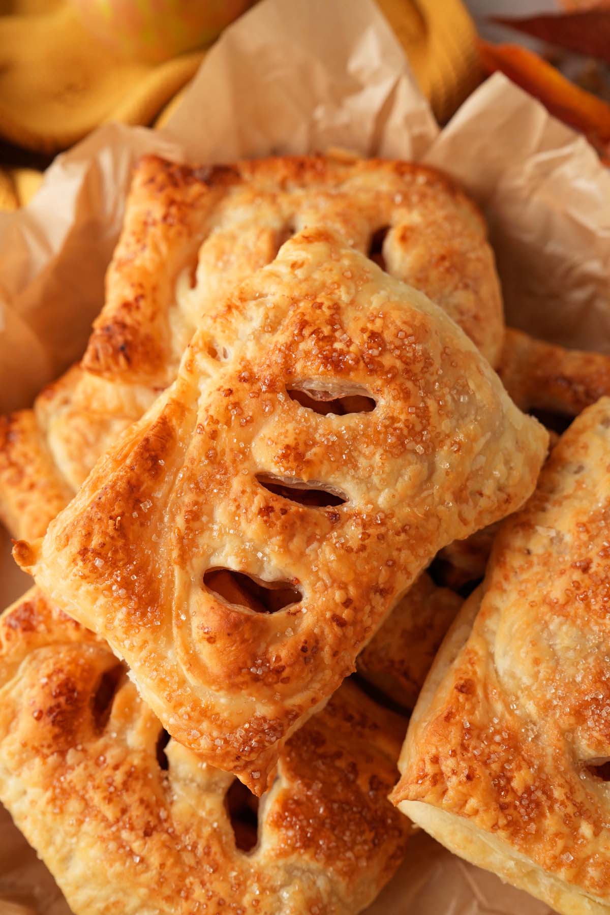 An up-close shot of apple hand pies with 3 slits in each.